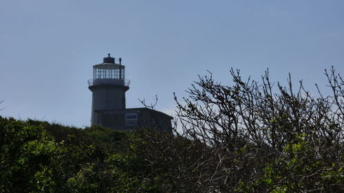 Low angle view of lighthouse against clear blue sky