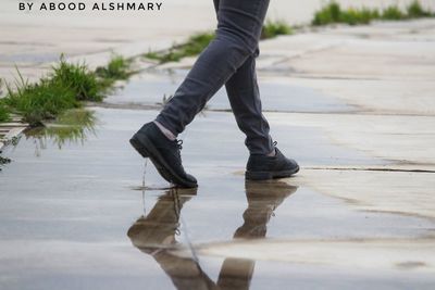 Low section of man walking on footpath