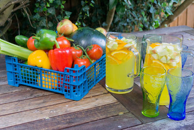 Close-up of drink in glass by vegetables on table