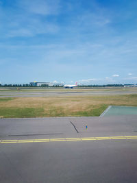 Airplane on runway against sky