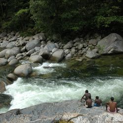 High angle view of men on rock by river