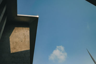 Low angle view of modern building against blue sky