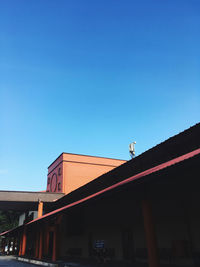 Low angle view of building against clear blue sky