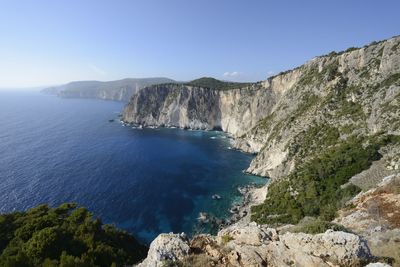 Scenic view of sea and mountains against clear sky