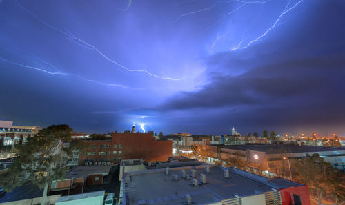 High angle view of lightning over buildings in city
