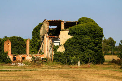 Old ruin on field against clear sky