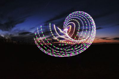 Light painting against sky at night