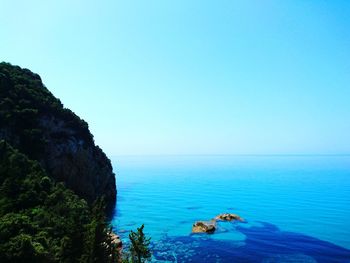 Scenic view of sea against clear blue sky