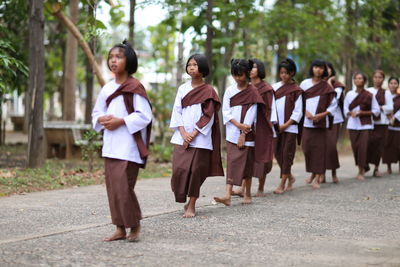 Group of people walking on footpath