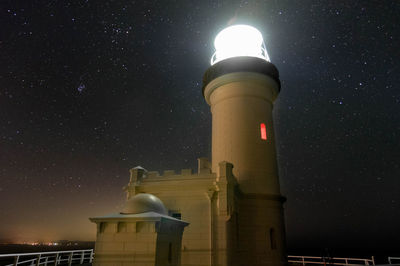 Low angle view of illuminated building against sky at night