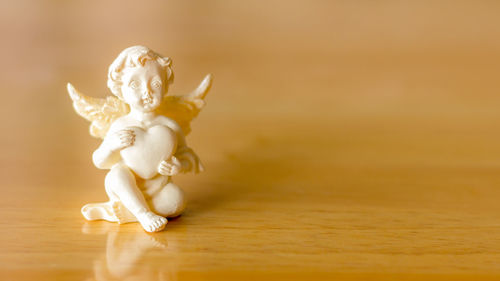 Close-up of figurine on table at home