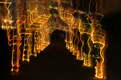 Close-up of illuminated lights against sky at night
