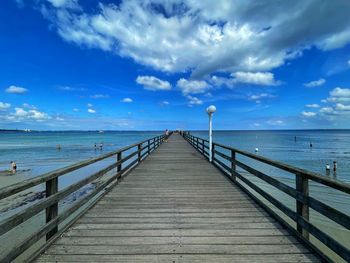 Pier over sea against sky