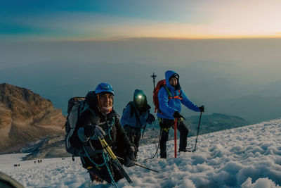 People skiing on snow covered mountain