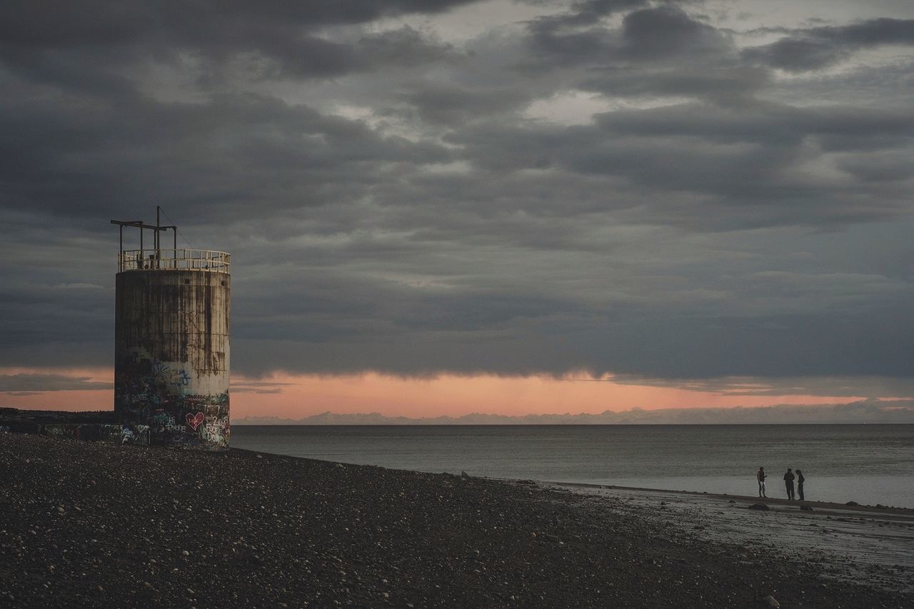 sky, cloud - sky, beach, water, sea, land, nature, sunset, incidental people, beauty in nature, dusk, horizon, sand, architecture, horizon over water, outdoors, built structure, scenics - nature