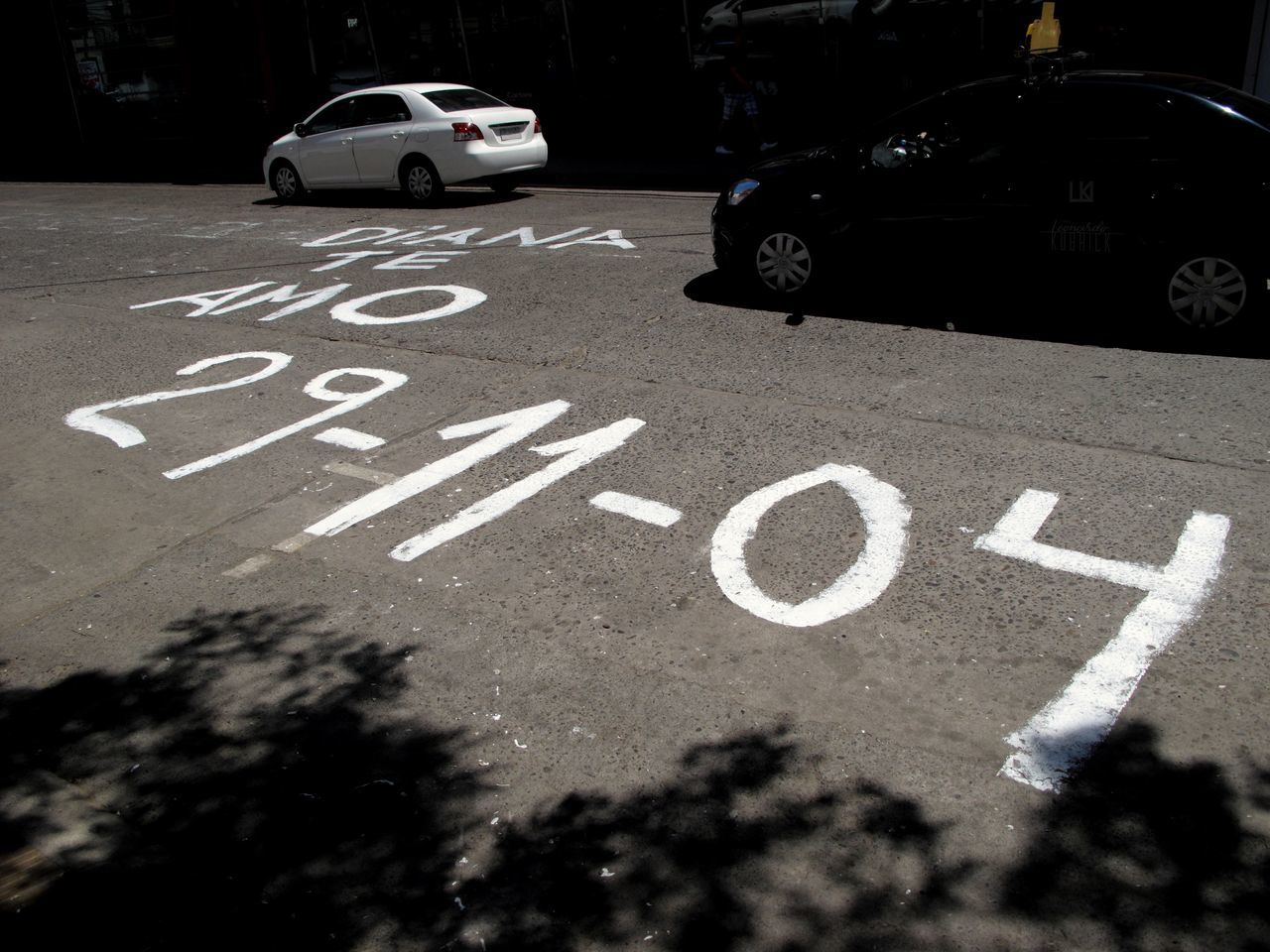 car, transportation, motor vehicle, mode of transportation, road, sign, city, land vehicle, communication, street, road marking, symbol, marking, text, no people, day, road sign, western script, white color, outdoors