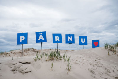 Pärnu sign on sand dunes at pärnu beach.