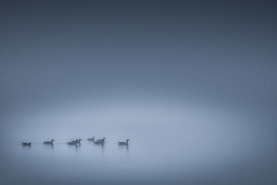 Scenic view of lake against sky during winter