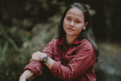 Portrait of beautiful woman sitting outdoors