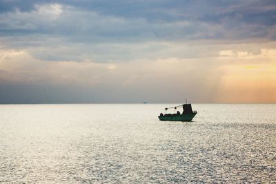 Boat sailing in sea against sky