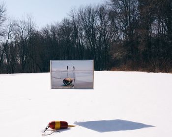 Tractor in winter against sky
