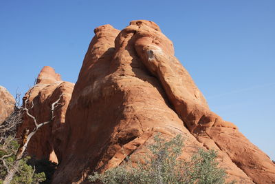 Low angle view of rocks against clear sky