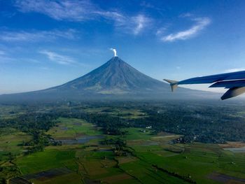 Scenic view of landscape against blue sky