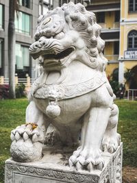 Close-up of statue against building in city