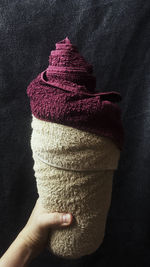 Close-up of hand holding ice cream cone