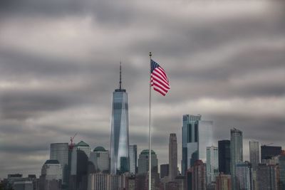 Low angle view of flag against cloudy sky