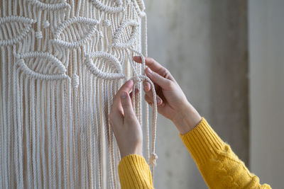 Cropped image of woman doing macrame