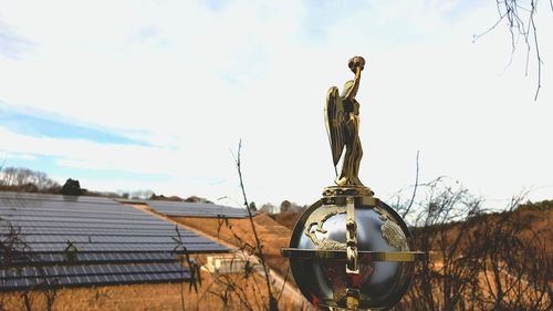 Low angle view of statue against sky