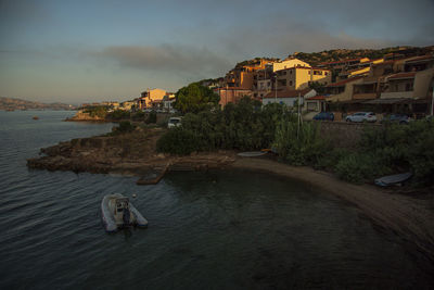 High angle view of buildings by sea against sky