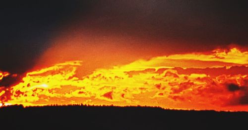 Scenic view of dramatic sky at sunset