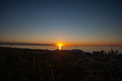 Scenic view of sea against clear sky during sunset