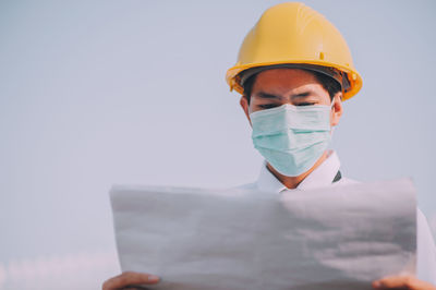 Man working against the sky