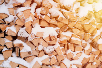 Textured firewood background chopped wood for kindling. woodpile with stacked firewood birch tree