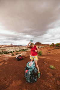 Full length of woman standing on land against sky