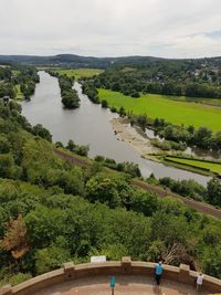 Scenic view of river amidst trees against sky