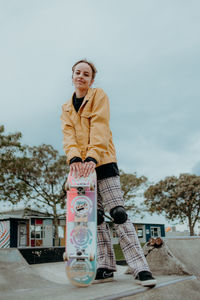 Portrait of girl standing against sky