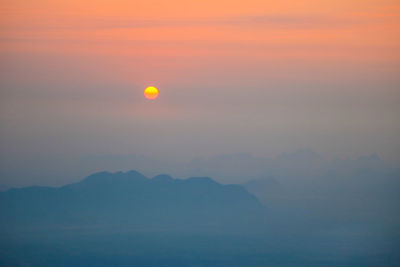 Scenic view of silhouette mountains against romantic sky at sunset