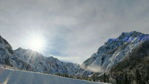 Low angle view of mountains against sky during winter