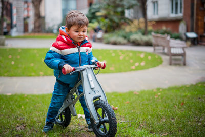 Boy with bicycle on grass