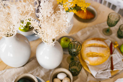 Rustic breakfast in a rustic home kitchen with farm eggs, green apple, fresh wheat bread. organic 