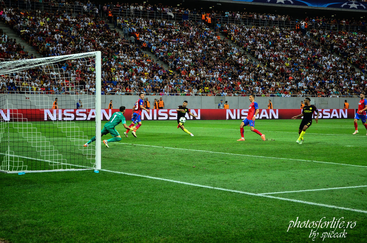 PEOPLE PLAYING SOCCER ON FIELD