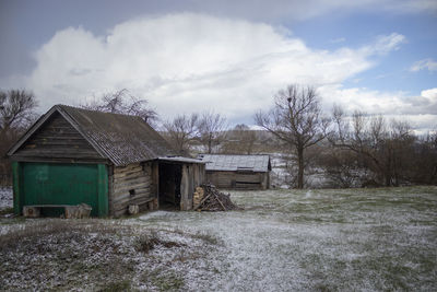 Barn on field against sky