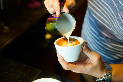 Close-up of hand holding coffee cup