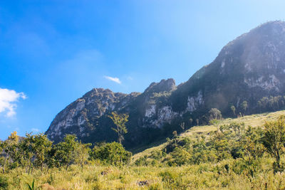 Scenic view of mountains against blue sky