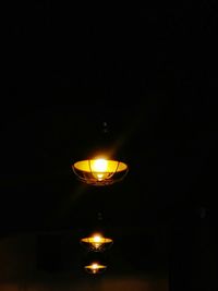 Close-up of illuminated lamp in darkroom