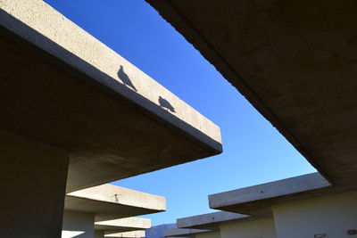 Low angle view of building against clear blue sky